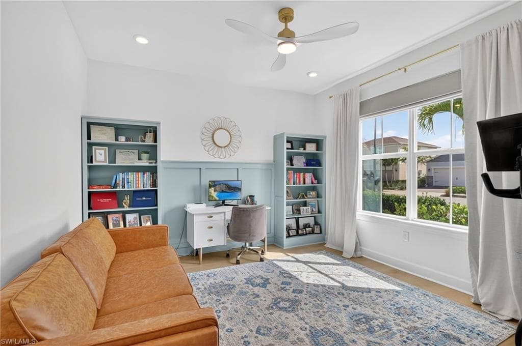Spacious room featuring light wood-finish flooring and a multi-pane window
