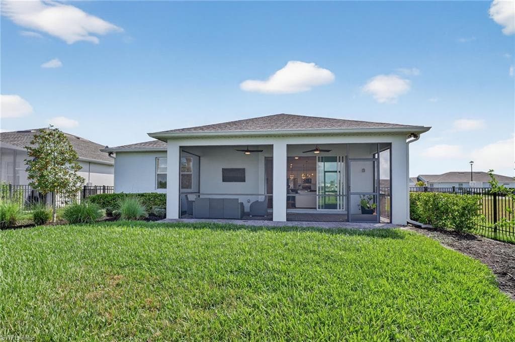 Expansive screened-in lanai with a ceiling fan, recessed lighting, and direct access to the interior