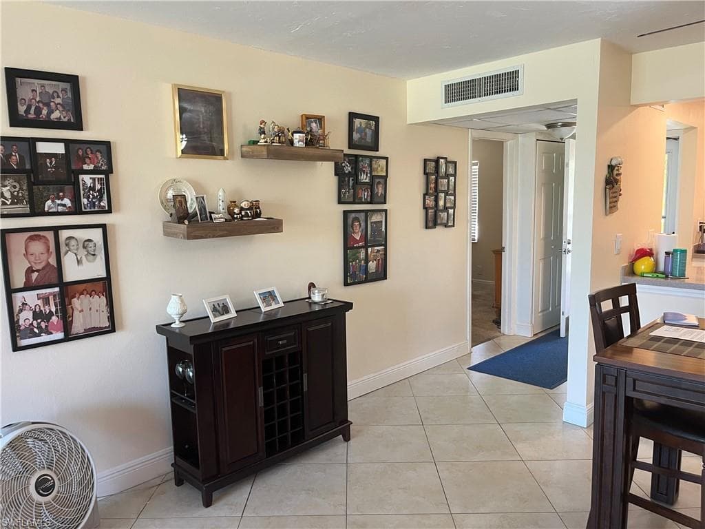Dining area with light tile patterned floors and baseboards