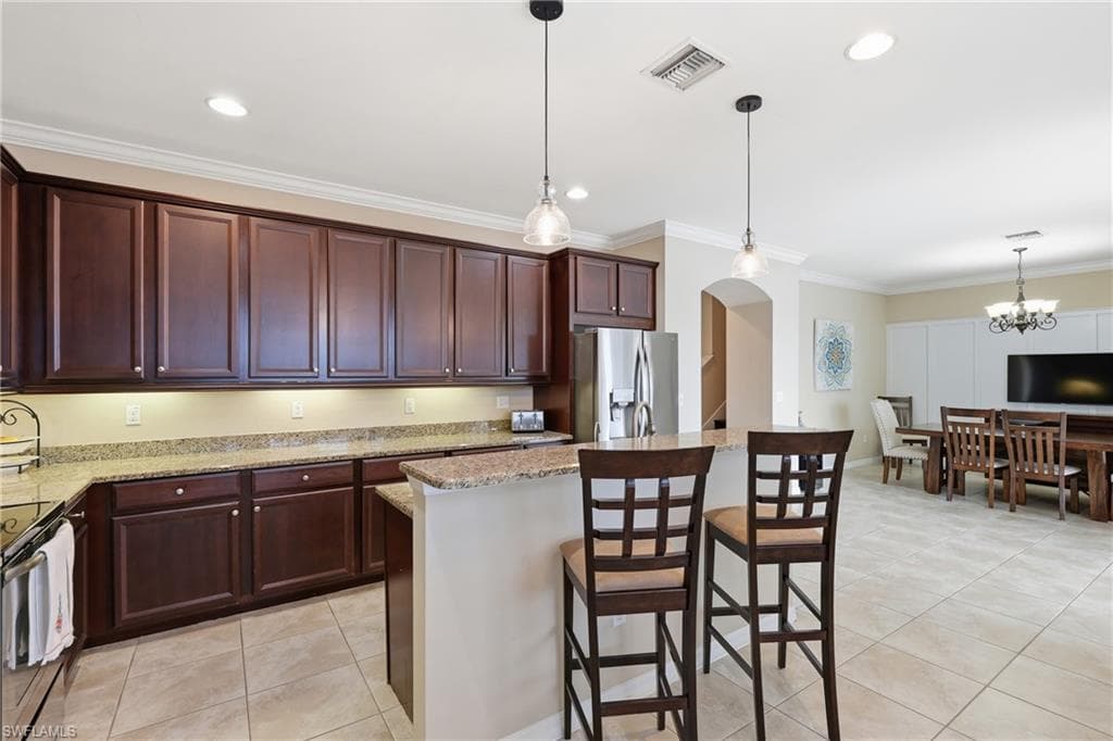 Kitchen featuring wood-finish cabinetry, granite countertops, and stainless steel appliances
