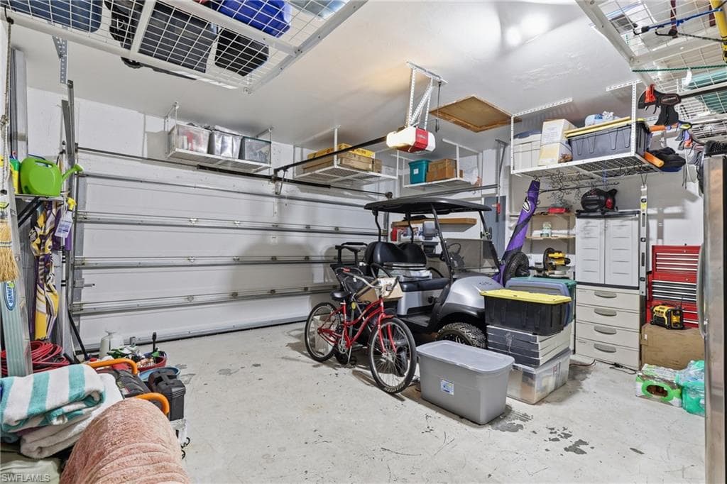 Garage featuring concrete flooring and a white sectional garage door