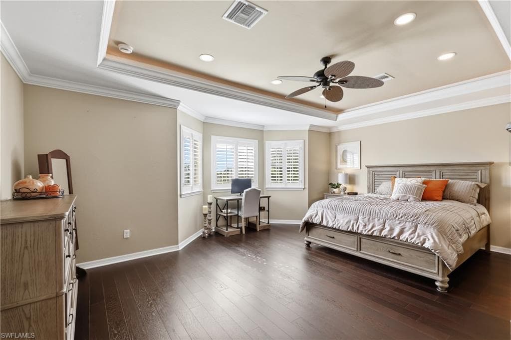 Spacious room featuring dark wood-finish flooring and light beige walls