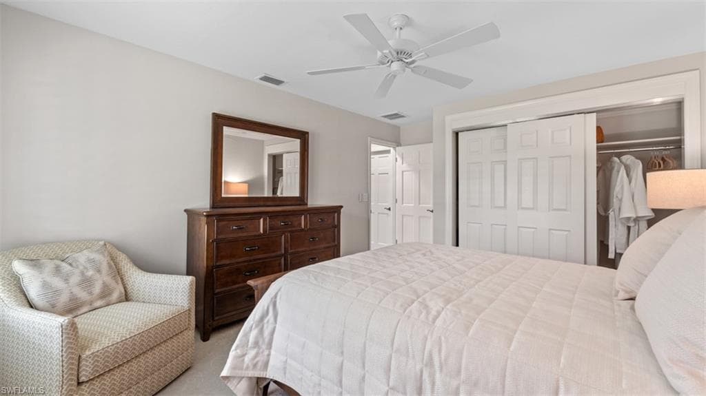 Neutral-toned interior featuring a white ceiling fan, white paneled bifold closet doors, and recessed lighting