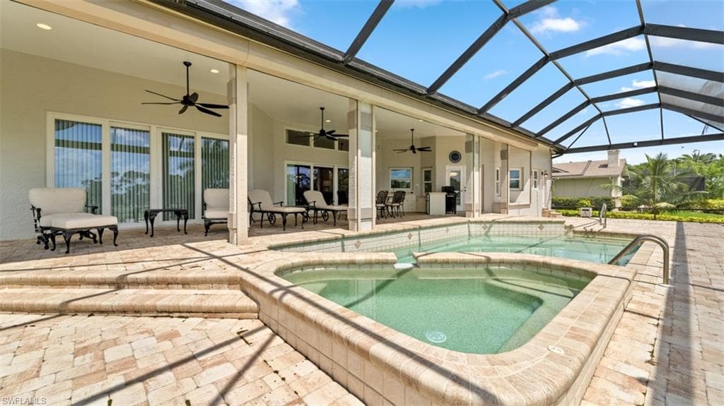 Expansive screened lanai featuring a swimming pool, integrated spa, and spacious covered patio areas