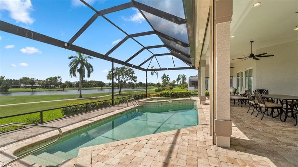 Screened lanai featuring a swimming pool, integrated spa, and paver patio