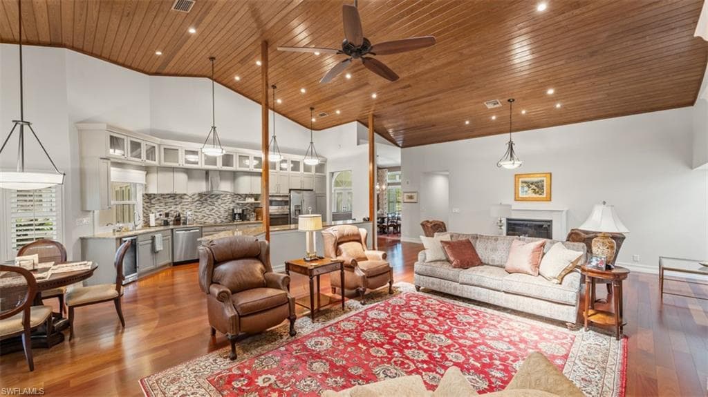 Open-concept living area with a wood-finish vaulted ceiling, recessed lighting, and a ceiling fan