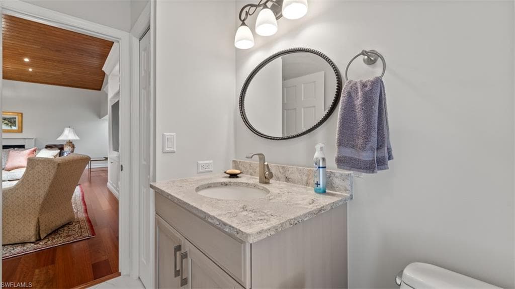 Pool Bathroom-- vanity featuring a light-toned countertop, under-mount sink, and contemporary faucet