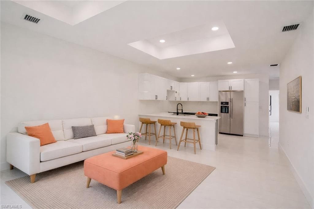 Unit A Photos include virtually enhanced appliances. Range is a front-control model without a rear panel, providing a full view of the backsplash.