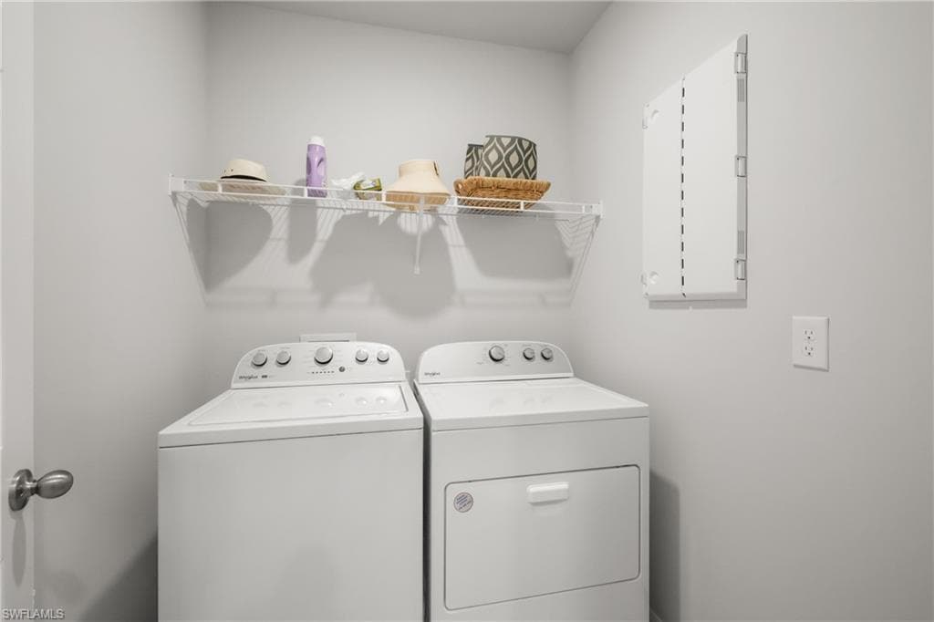 Dedicated laundry area featuring a white wire shelving unit
