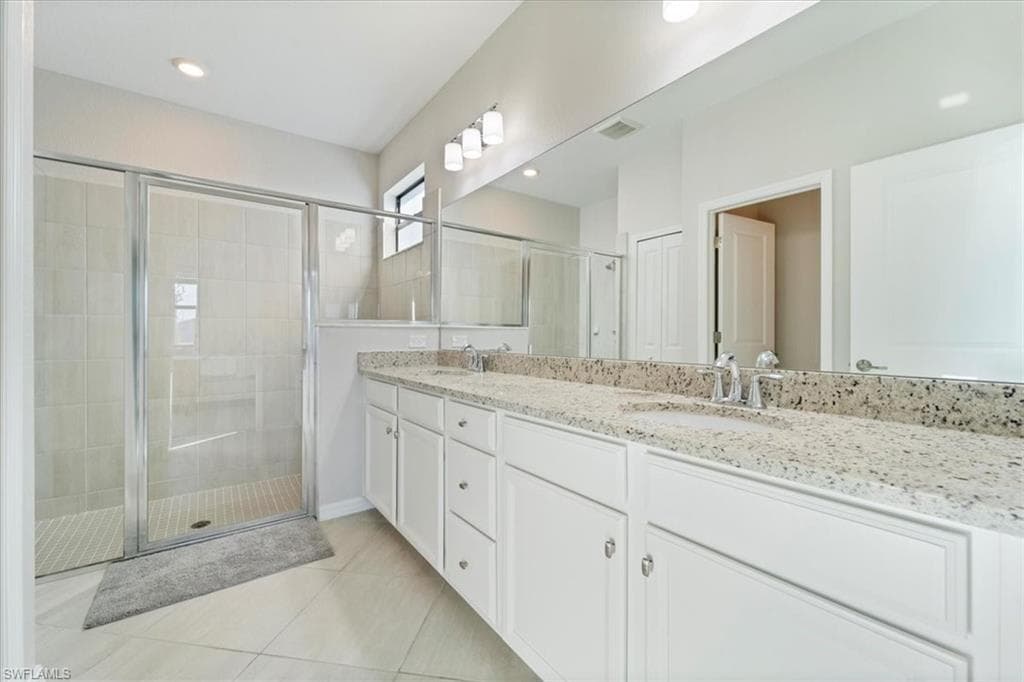 Dual vanity with granite-style countertops and white cabinetry