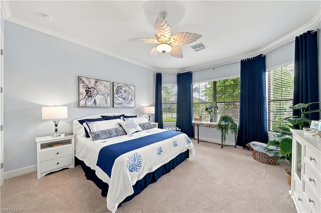 Spacious room featuring light-toned walls, crown molding, and carpeted flooring