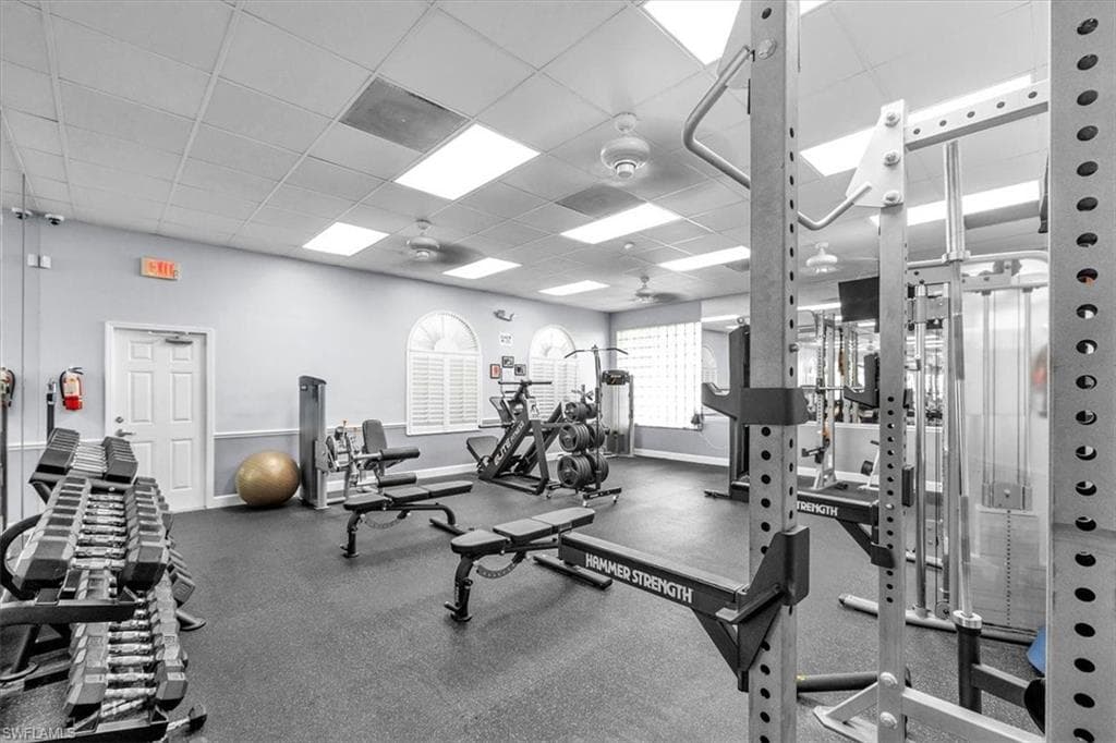 Dedicated fitness center featuring rubber flooring and extensive workout equipment
