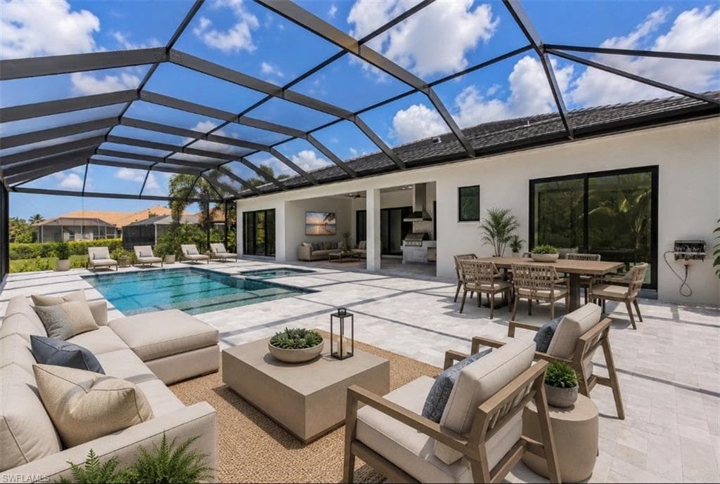 VIrtual Staged Screened outdoor living area with a rectangular swimming pool and integrated spa