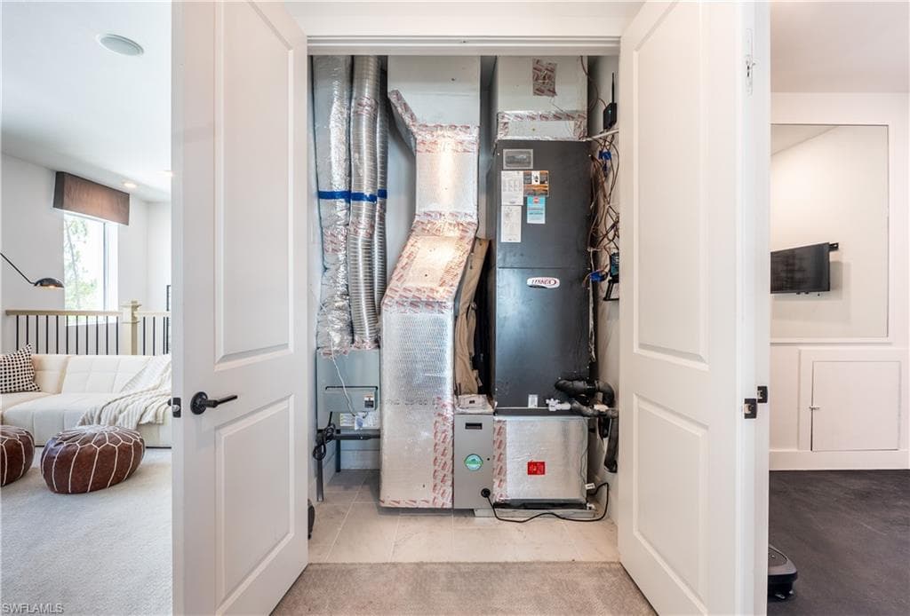 Utility closet featuring a Lennox furnace and extensive ductwork