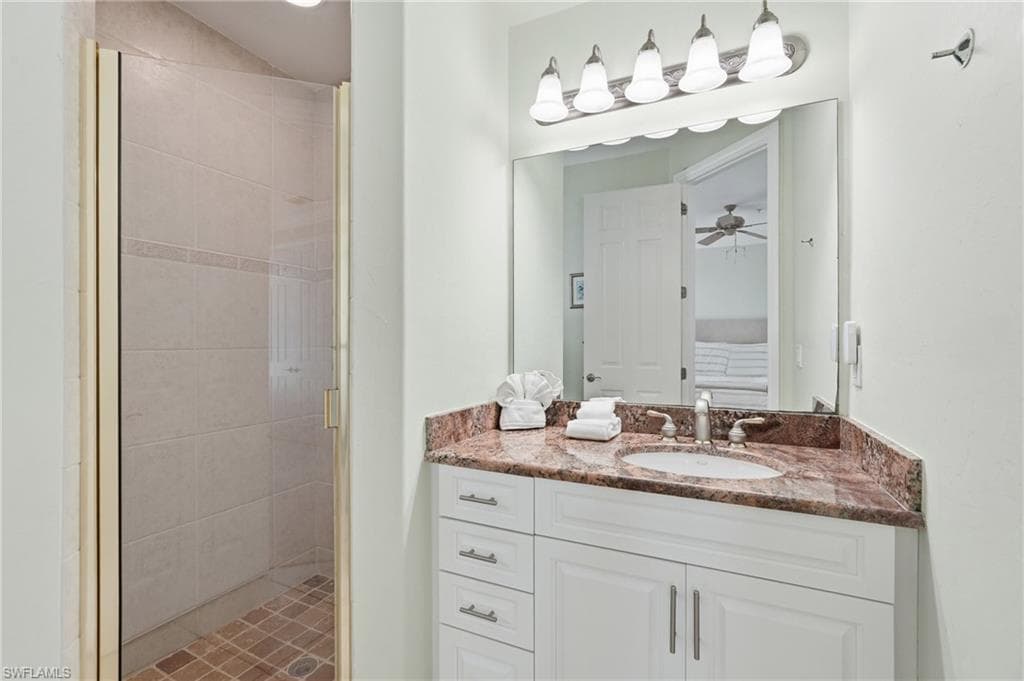 White vanity with a built-in sink, stone countertop, and brushed nickel fixtures - Virtually Edited Image
