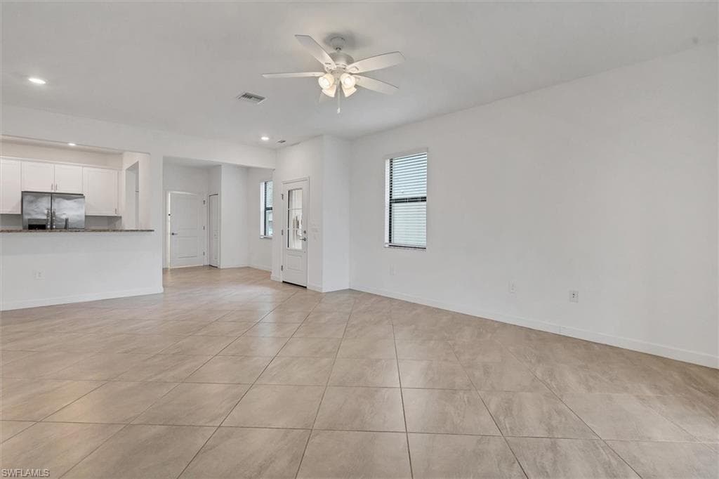 Unfurnished living room featuring light tile patterned flooring, recessed lighting, and ceiling fan