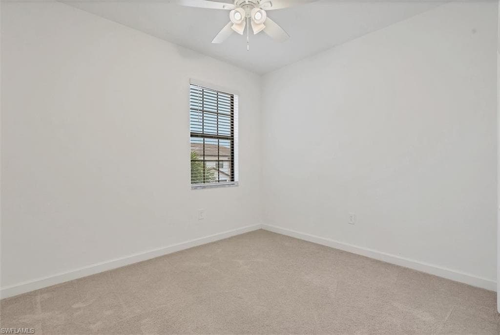 Spare room with light colored carpet and ceiling fan