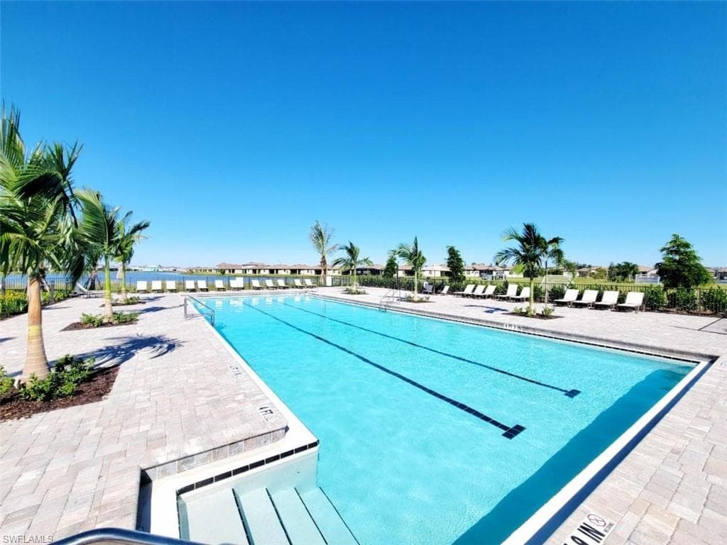 Community pool with a patio