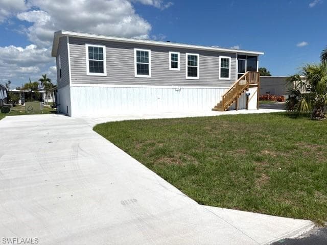 SW side of home with large curved drive
