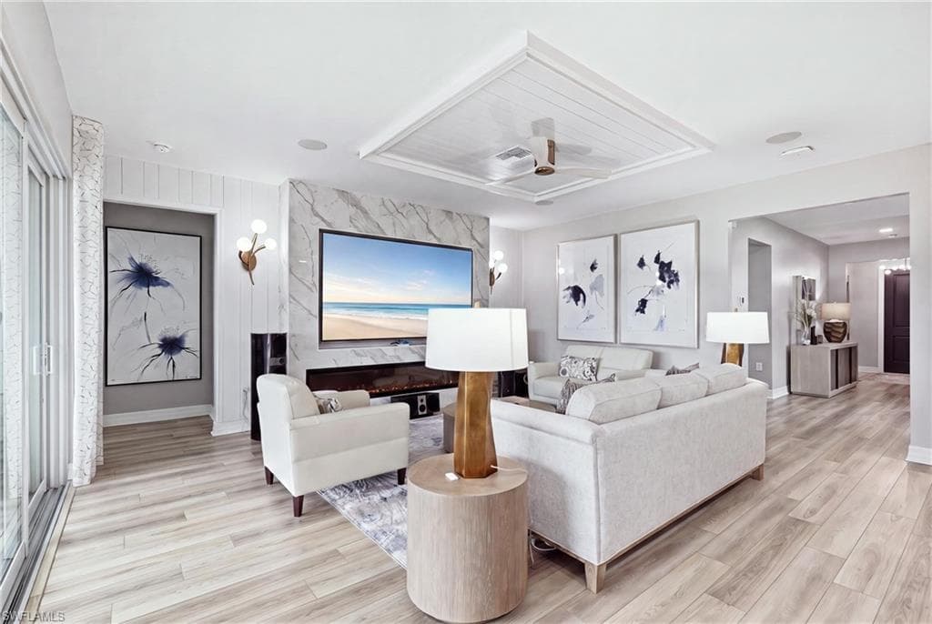 Open-concept living highlighted by a customer tray ceiling and designer finishes
