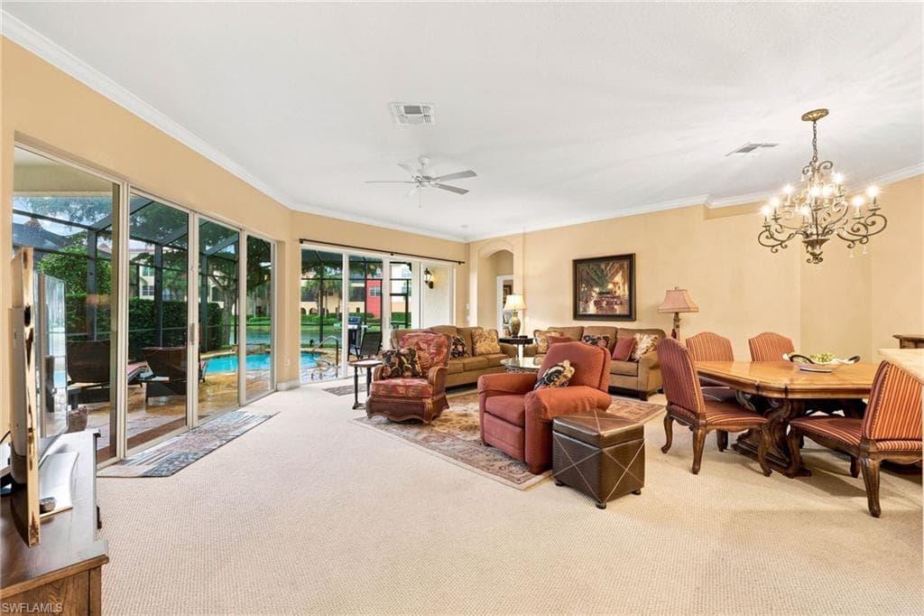 Curved wall of sliding glass doors opening to a screened lanai with a pool