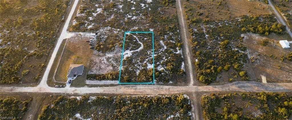 Vacant land parcel featuring natural scrub vegetation and a rectangular lot shape