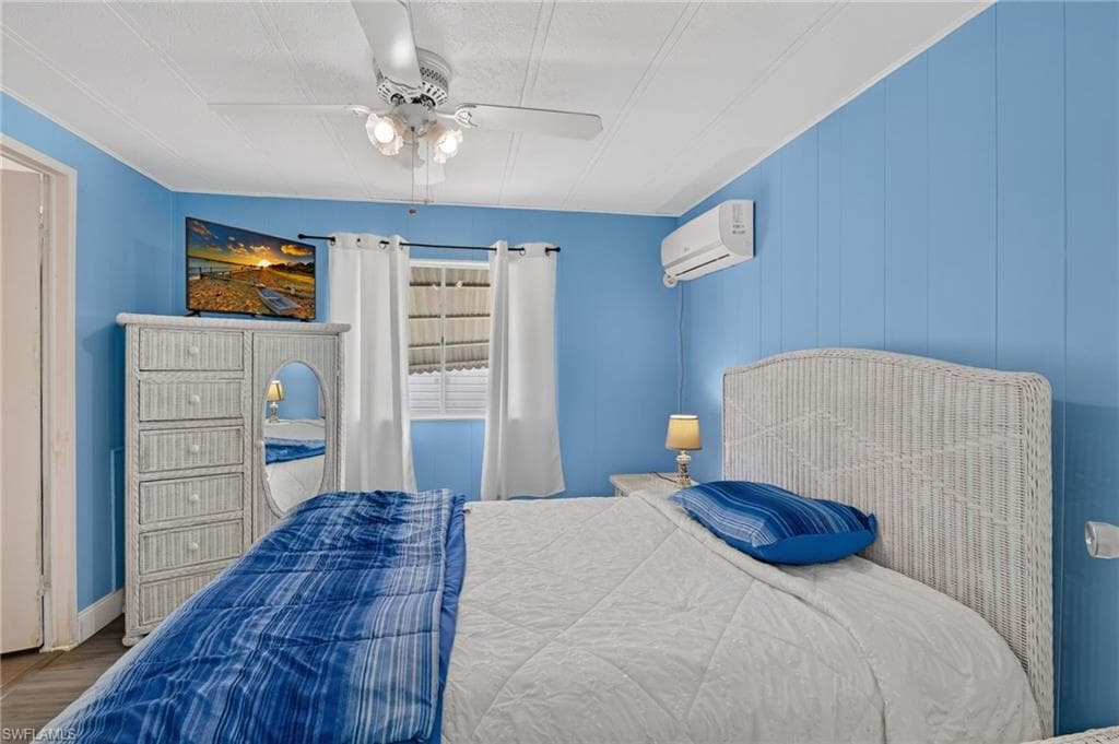 Board and batten wall paneling in a vibrant blue finish with a suspended ceiling fan