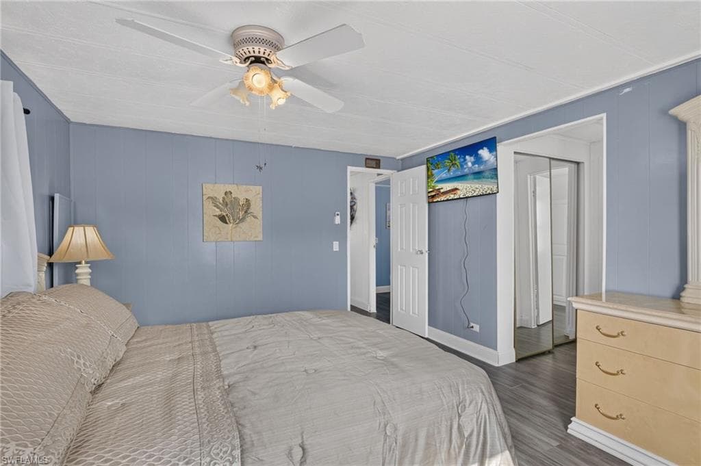 Room featuring blue paneled walls and wood-finish flooring