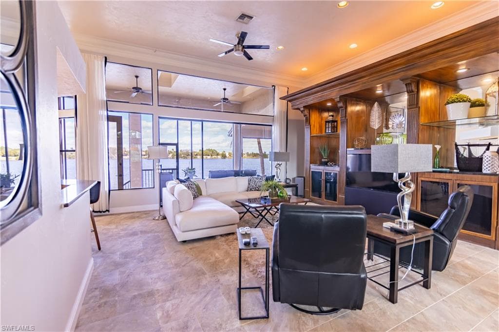 Expansive living area featuring large windows showcasing waterfront scenery