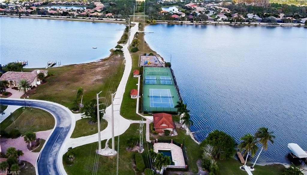 Waterfront community featuring multiple tennis courts, a swimming pool, and dedicated docks