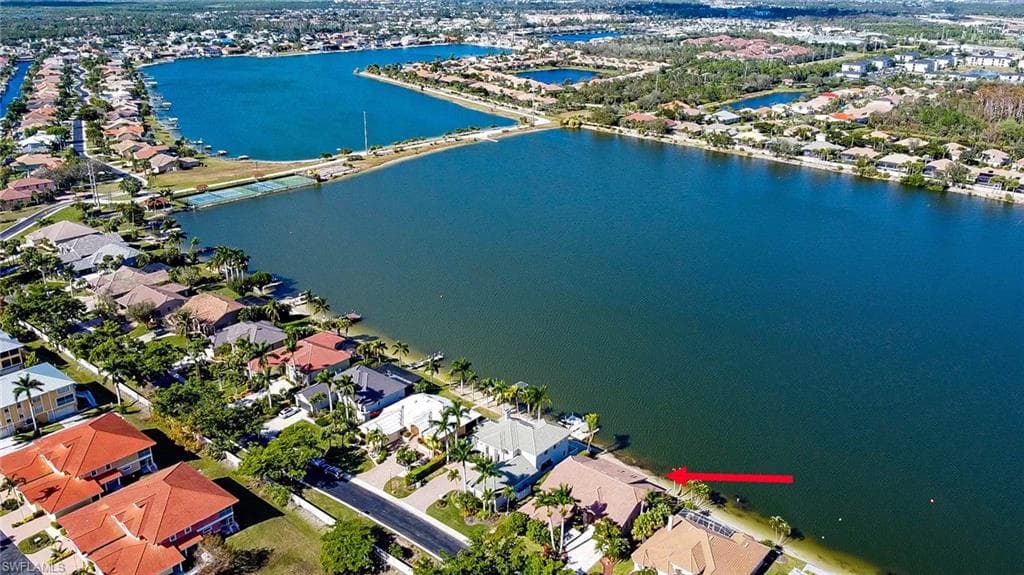 Waterfront property featuring a private boat dock, direct water access, and a spacious outdoor area
