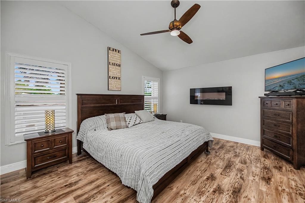 Room featuring vaulted ceilings and wood-finish flooring
