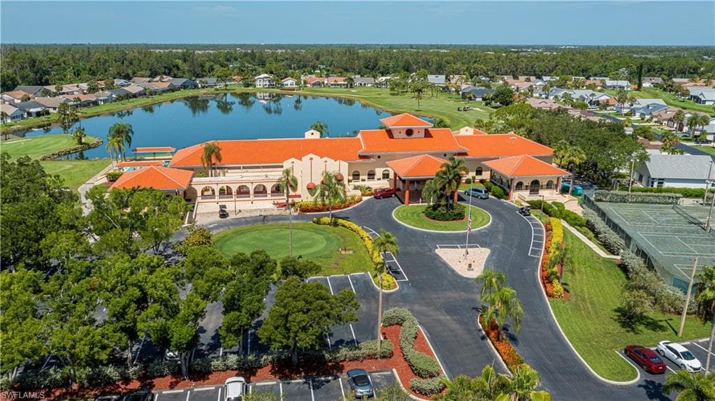 Mediterranean-style clubhouse featuring a prominent tile roof and arched entryways