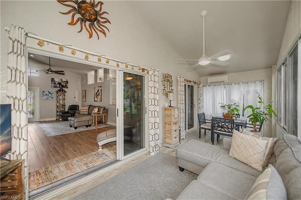 Enclosed patio featuring a vaulted ceiling and a modern ceiling fan