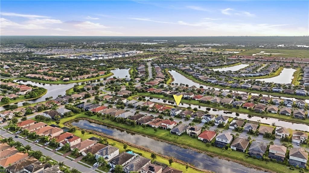 Aerial perspective showcasing a residential community with water features