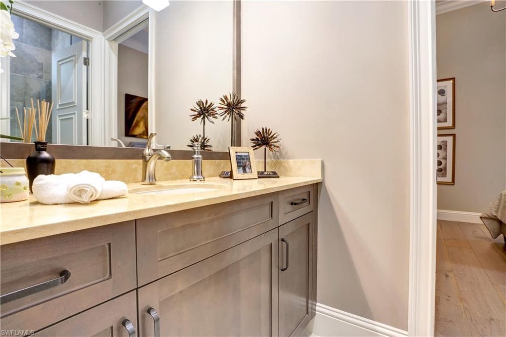 Bathroom vanity featuring light-toned cabinetry, a light-colored countertop, and a built-in sink