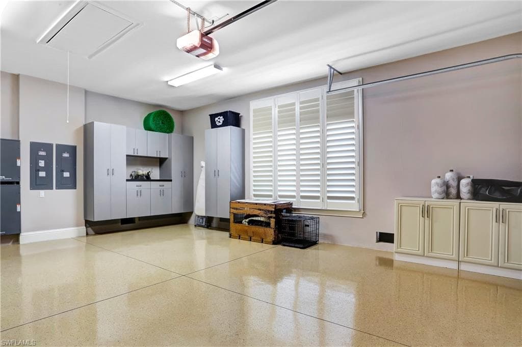 Epoxy-coated flooring with integrated control panels, overhead lighting, and extensive built-in cabinetry featuring a countertop workstation