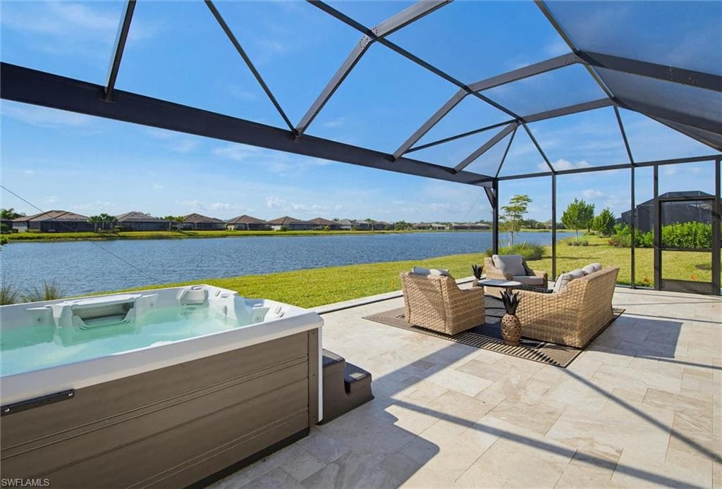 View of patio featuring a residential view, a water view, a lanai, a sunroom, and an outdoor lounge area