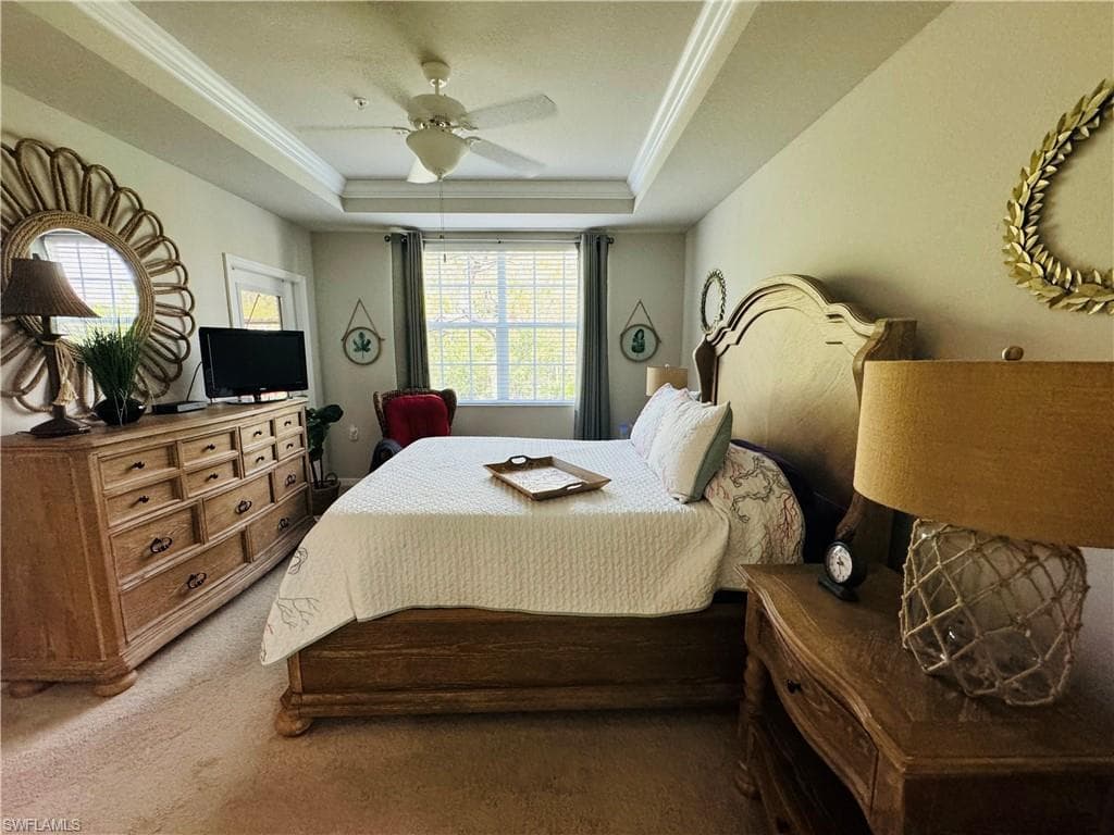 Primary bedroom with picture window overlooking woods