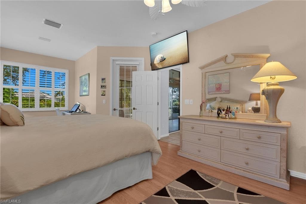 Bedroom featuring wood-finish flooring and vaulted ceilings