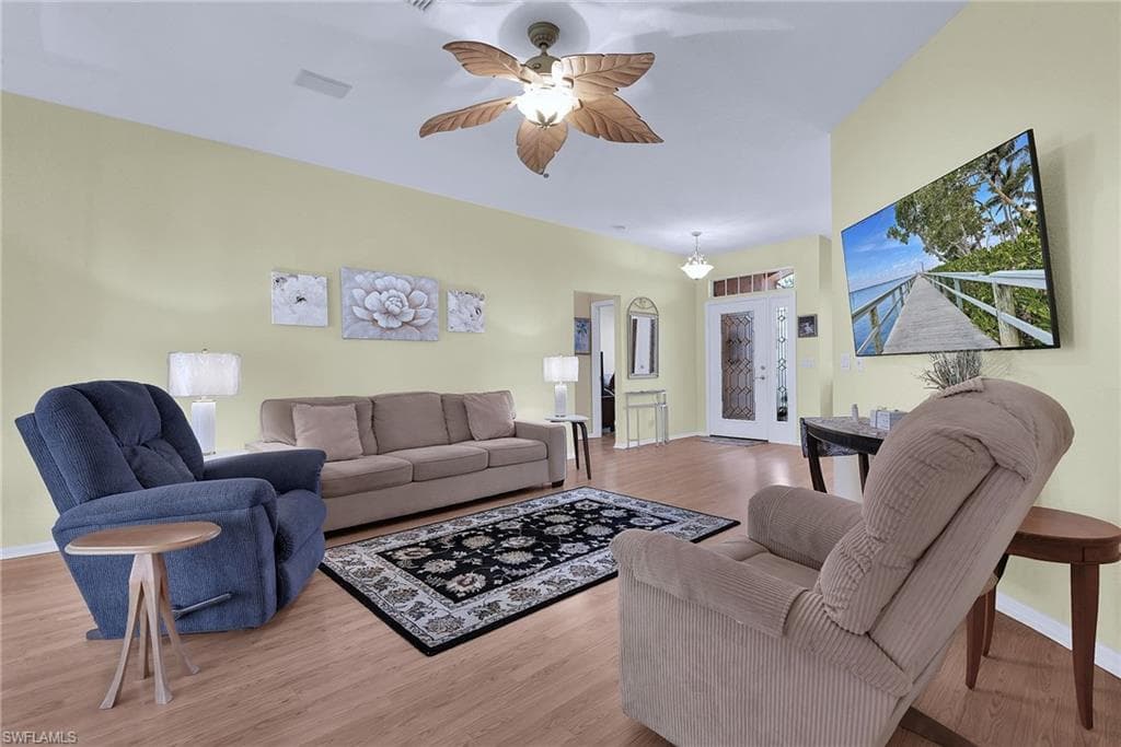 Light wood-finish flooring throughout, complemented by a decorative ceiling fan with integrated lighting