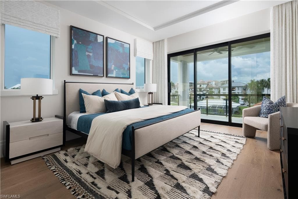 Spacious room featuring wood-finish flooring, recessed lighting, and a tray ceiling
