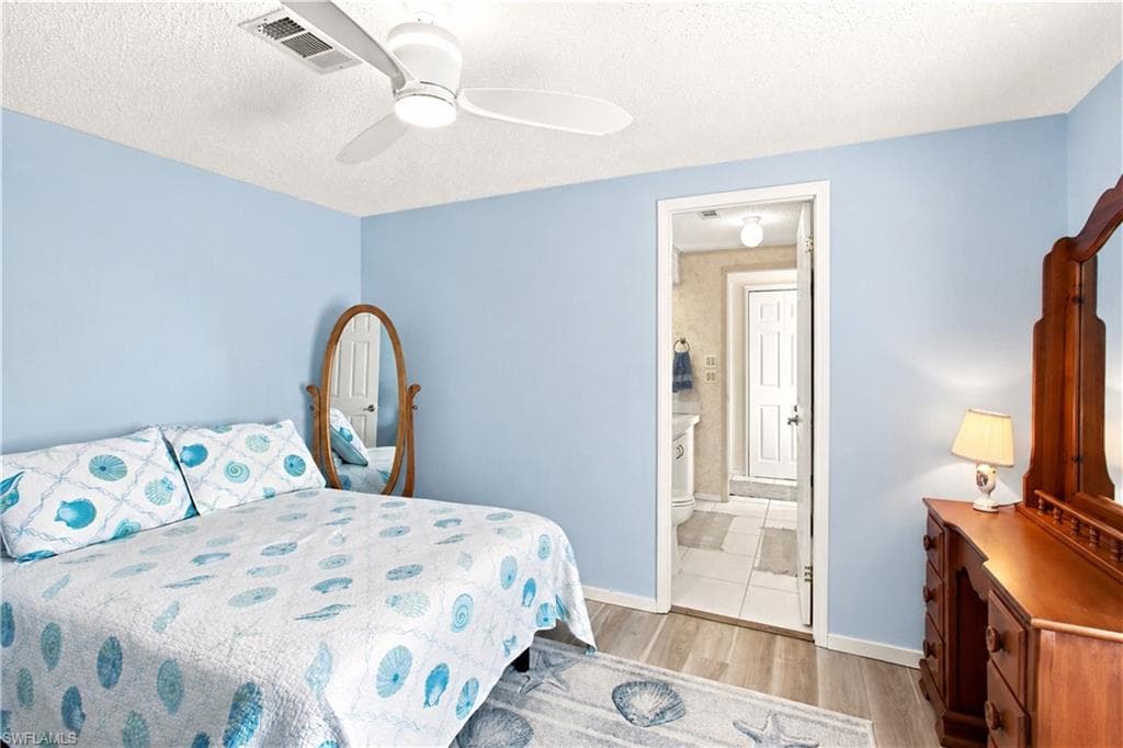 Spacious room featuring light blue walls and wood-finish flooring