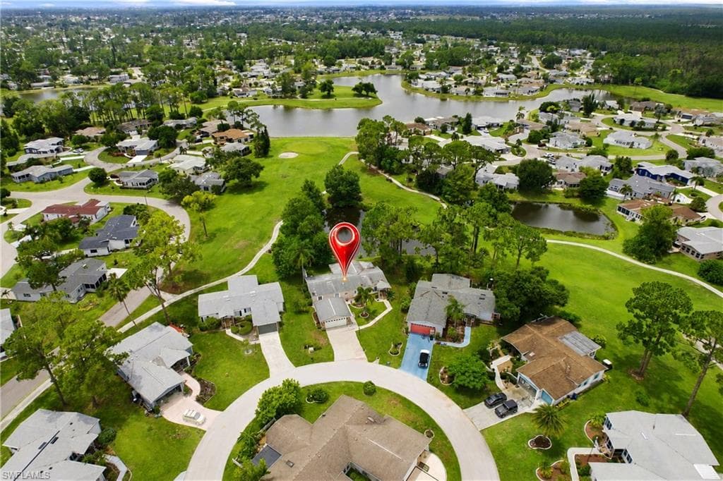 Aerial perspective of a residential community featuring single-story homes with gray roofs