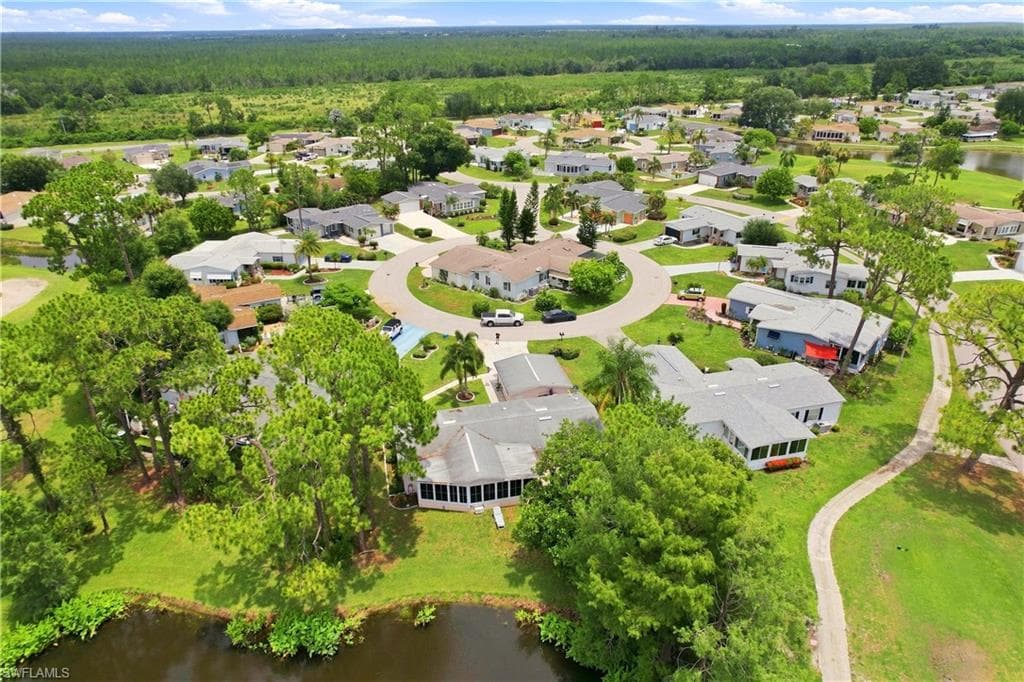 Expansive residential community featuring mature landscaping and a serene water feature