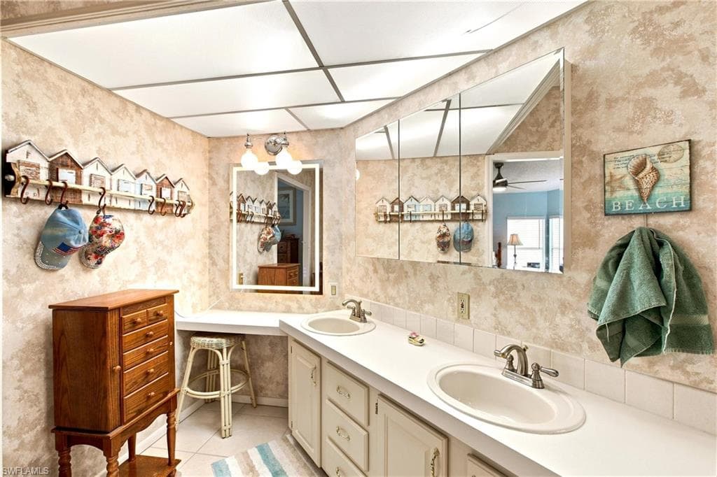 Double vanity with integrated sinks, expansive counter space, and wall-mounted mirrors