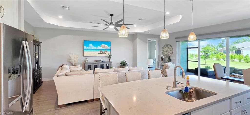 Kitchen featuring white shaker-style cabinetry, stainless steel appliances, and light-toned countertops