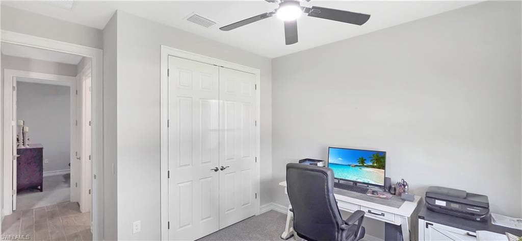 Room featuring light gray wall paint, a ceiling fan with integrated lighting, and a white paneled bi-fold closet door
