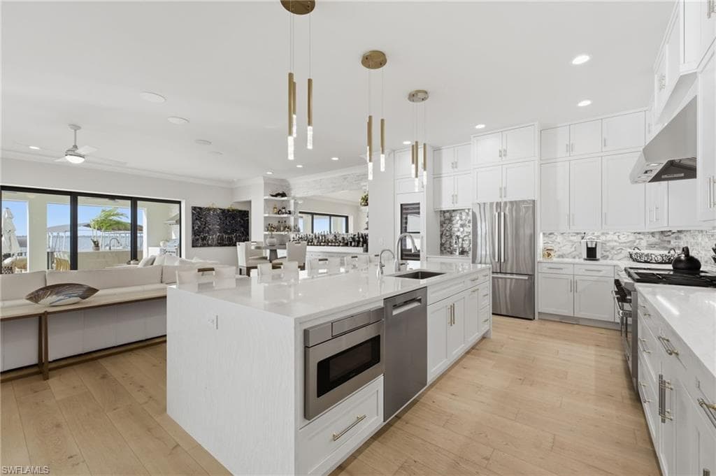 From the kitchen, expansive views of the river create a breathtaking backdrop, bringing the beauty of the waterfront into every culinary and entertaining experience.