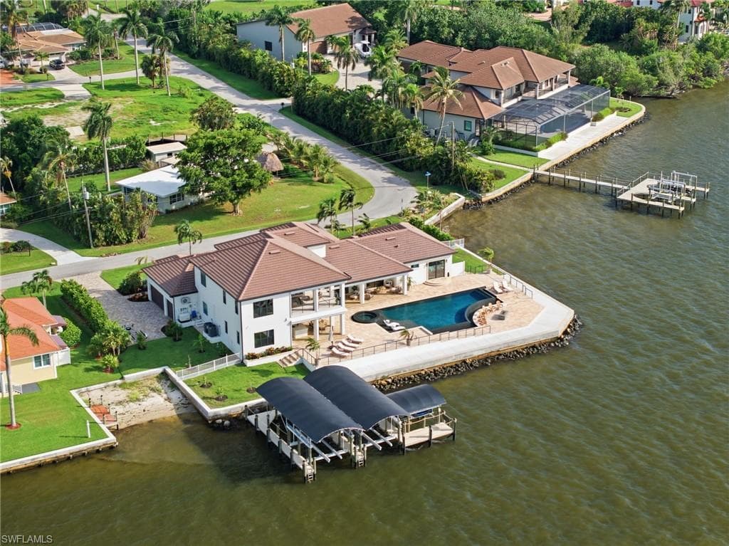 Set across two private homesites, this extraordinary waterfront estate offers a rare sense of seclusion and privacy, framed by unobstructed views of Southwest Florida’s spectacular sunsets. Each evening, the sky becomes a breathtaking masterpiece, creating an unparalleled backdrop for refined waterfront living.